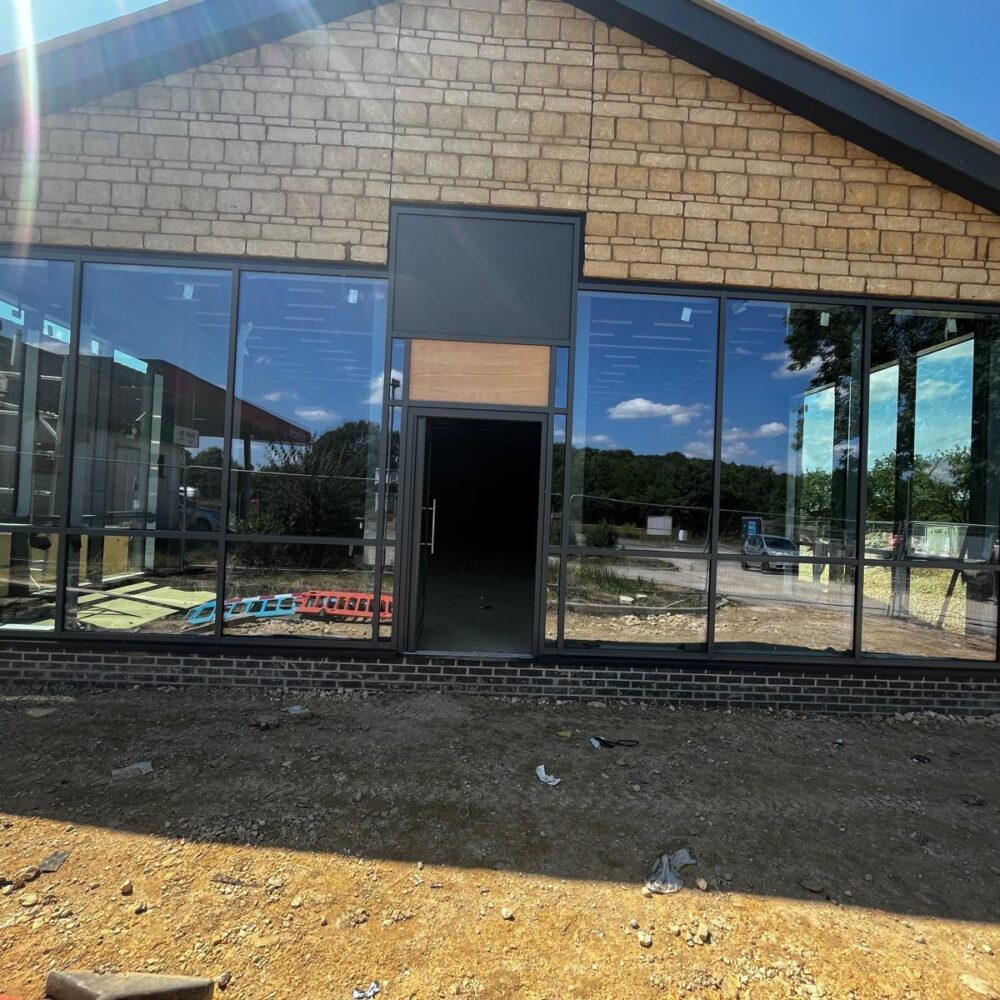 2. Commercial façade with curtain walling and doors at Ram Jam Services Rutland