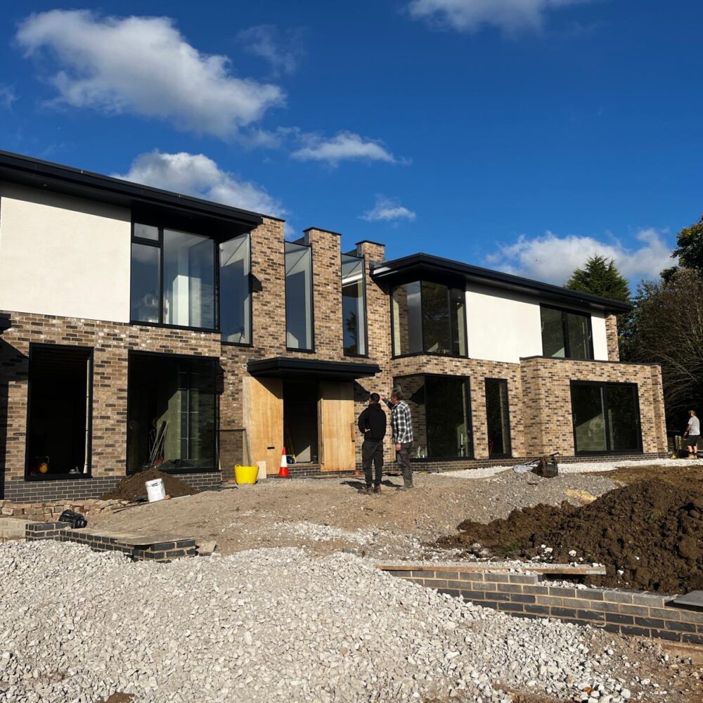 Modern residential glazing with large aluminium windows and field views